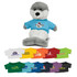 A grey and white plush seal toy wearing a blue T-shirt, accompanied by various coloured shirts in the background.