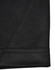 A close-up of a black polo shirt featuring a smooth fabric texture and detailed stitching.