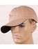 A tan cap with a contrasting dark peak, displayed on a mannequin head. The cap features a logo on the side.