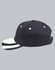 A black structured cap with a contrasting white peak and decorative stripes on the brim, featuring a logo.