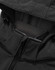 A close-up of the black softshell hoodie with a zippered pocket and a hood. It features a logo on the fabric.