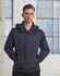 A man wearing a navy versatile jacket, standing with hands in pockets against a backdrop of large windows.