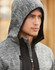 A grey work hoodie featuring a hood and a zippered front, displayed on a model with a neutral background.