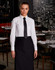 A long-sleeve white cotton/poly stretch shirt with a black tie, worn in a stylish dining setting.