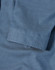 A blue pin dot stretch shirt featuring a 3/4 sleeve and folded cuff detail. Includes a logo.