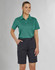 A woman in a teal polo shirt and navy utility cargo shorts, standing confidently with hands in pockets.