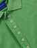 A green polo shirt featuring a classic collar and button placket, with a logo on the label.