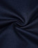 A close-up of textured navy fabric, showcasing the sustainable poly/cotton blend used in kids' polo shirts.
