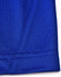 A close-up of a blue polo shirt featuring contrast stitching and a tag with a logo.
