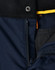 A close-up of navy Rip-Stop Poly/Cotton Stretch Work Pants, showcasing the zipper and fabric texture. Features a logo.