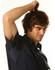 A dark blue short-sleeved cotton work shirt displayed on a young man with tousled hair, featuring a logo on the chest.
