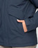 A unisex quilted waterproof jacket in navy blue, featuring a pocket and a close-up of the material.