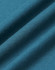 A close-up of a textured fabric in deep teal, showcasing the softness and weave of the premium cotton material.