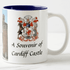 A mug featuring a photograph of Cardiff Castle and a decorative coat of arms, with a blue interior.