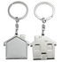 A silver keyring set featuring house-shaped designs, one with a flat surface and the other with a door detail.
