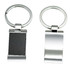 A keyring featuring a sleek silver design with a rectangular black panel on one side and a shiny silver surface on the other.