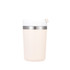 A drink mug in a soft pink colour with a stainless steel band and a white lid. It features a logo.