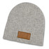 A grey cable knit beanie with a leather patch. The beanie has a soft, textured appearance.