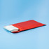 A red pouch containing a white fiberglass emergency fire blanket. Features a snap closure.