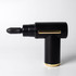A black massage gun with gold accents, featuring a pointed attachment and a sleek, modern design.
