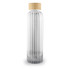 A drink bottle with a ribbed glass design and a bamboo lid, featuring a clear and elegant appearance.