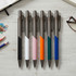 A display of six Arc Metal Pens in black, white, pink, orange, teal, and blue, featuring a branding logo.
