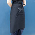 A black long waist apron with a side pocket, featuring a logo on the front.