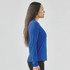 A blue long-sleeve women's tee, featuring a crew neckline and a side profile view of a model.