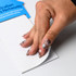 A hand with stylish nails holds a telephone-shaped notepad, featuring lined pages and a blue branded top.