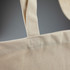 A light beige recycled cotton tote bag featuring sturdy shoulder straps and a simple design, with a branding logo.