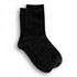 A pair of black ribbed lounge socks with a comfortable fit, featuring a simple design. They have a brand logo.