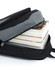 A black and grey backpack partially open, revealing several stacked books inside. It features a logo on the exterior.