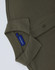 An olive green men's classic cotton/poly pique short sleeve polo, featuring a collar and buttons. It has a logo.