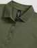 A green ladies polo shirt with a collared neck and a button placket, featuring a logo tag inside.