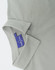 A grey ladies' high performance graphene polo with a collared neckline and a hidden button placket, featuring a logo.