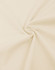 A close-up of light beige fabric, showcasing a smooth, oversized cotton texture with a flowing twist.