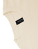 A beige unisex heavy cotton oversized tee featuring a label on the sleeve.