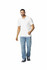 A man wearing a white Gildan Hammer Adult Double Pique Polo with blue jeans and sneakers, smiling and walking.