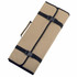 A folded tan and black BBQ set, secured with straps and featuring a handle for easy carrying.