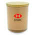 A large, beige candle in a glass container with a wooden lid and a logo on the front.