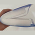 A blue full-length face shield held in a hand, featuring a white foam lining and elastic straps.