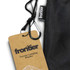 A black camping blanket with a carabiner and a tag. The tag features branding and product details.