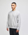 A grey Champion Reverse Weave® adult crew sweatshirt with a logo, modelled by a person.