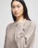 A model wearing a grey Champion Reverse Weave® adult crew sweatshirt, showcasing a casual style.