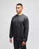 A grey crewneck sweatshirt on a model, featuring a logo on the sleeve and a relaxed fit.