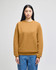 A model wears a mustard-coloured Champion Powerblend® crewneck sweatshirt, paired with blue jeans.