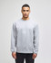 A grey Champion Powerblend® adult crewneck sweatshirt with a logo, featured on a model in casual attire.