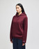 A maroon pullover hooded sweatshirt with a front pocket and logo branding, worn by a model.