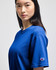 A blue Champion adult short-sleeve t-shirt displayed on a model, featuring a small logo on the sleeve.