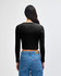 A black cropped long-sleeve fitted T-shirt seen from the back, paired with blue jeans.